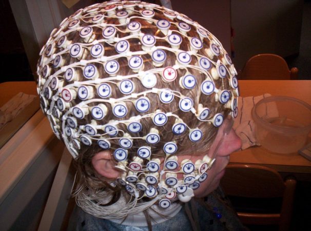 Brain researcher Dennis Molfese places a net of 256 electrodes over an athlete’s head to track brain activity before and after a concussion. The electrodes pinpoint which regions of the brain are most active during tests of attention and memory. Credit: Courtesy of Dennis Molfese