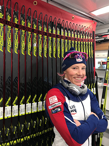 Kikkan Randall with several dozen skis