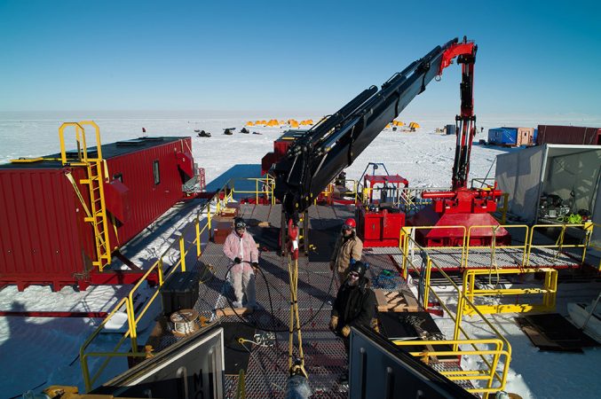 Engineers have assembled a metal platform over the spot where a half-mile-deep hole was drilled down to Lake Whillans. Some of the scientific equipment lowered into the lake was so heavy that it had to be lifted with a crane (right side of photo). Credit: © JT Thomas