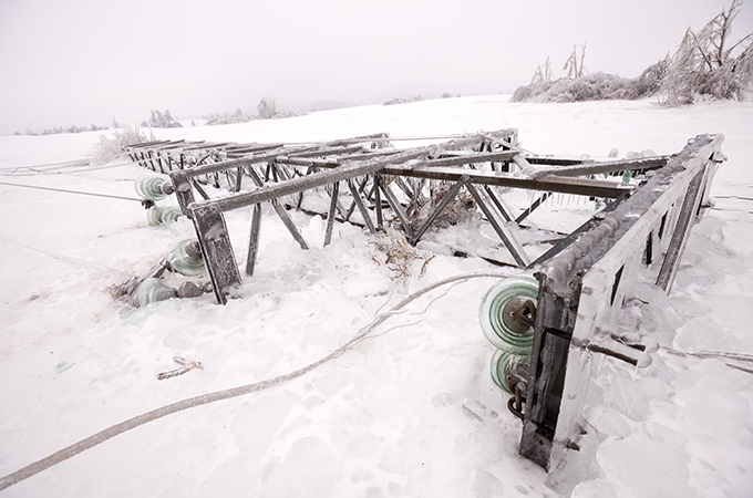 a photo of a power pole downed by an ice storm