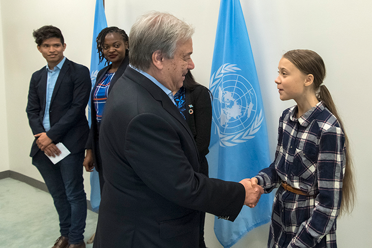 a photo of Greta Thunberg shaking hands with U.N. Secretary-General António Guterres