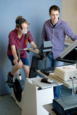 A boy rides a stationary bicycle that gets increasingly harder to pedal. The mouthpiece he’s wearing measures the air he breathes in and out. Scientists use that data to figure out the boy’s overall health and how well he is likely to perform at sports. Credit: CHERC, University of Exeter