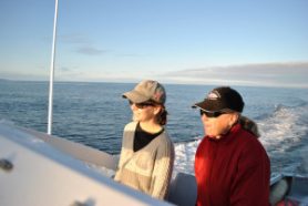 Moira “Moe” Brown (right) and Marianna Hagbloom, both biologists with the New England Aquarium, pilot the R/V Nereid out to the Bay of Fundy. Credit: Eric Wagner