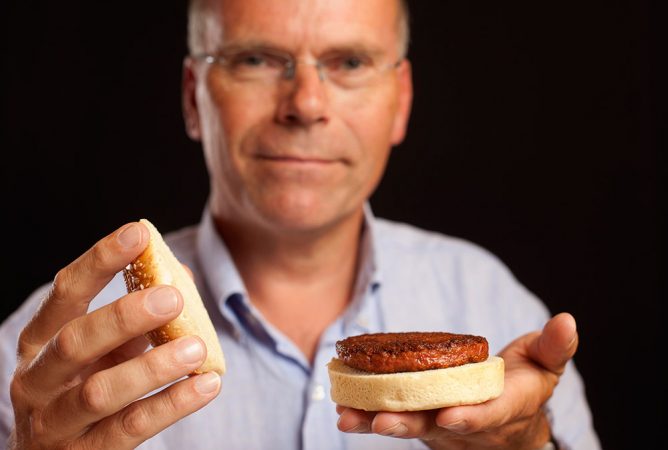 Mark Post holds a cooked cultured hamburger. Credit: David Parry / PA Wire