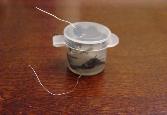 This tiny paint container is as wide as a quarter. It contains the fuel cell invented by Raja Selvakumar, 17.  His device steadily generates 700 millivolts of energy using bacteria isolated from yogurt. Credit: Raja Selvakumar