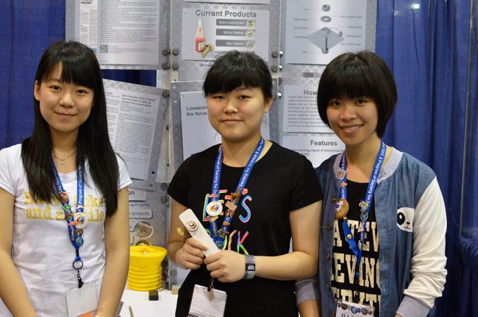 Mei Kam (left), Mei Di Zhu (center) and Jia Ying Zhong (right) designed a “smart washer” that provides an alert when the nut holding the washer on a bolt comes loose. Credit: Patrick Thornton, SSP