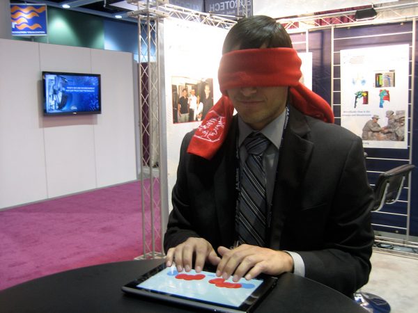 Adam Duran demonstrates his Braille note-taking app on an Android tablet at the Army High Performance Computing Research Center exhibit at Supercomputing 2011 in Portland, Ore. Credit: Nancy McGuire for the Army Research Laboratory, public domain