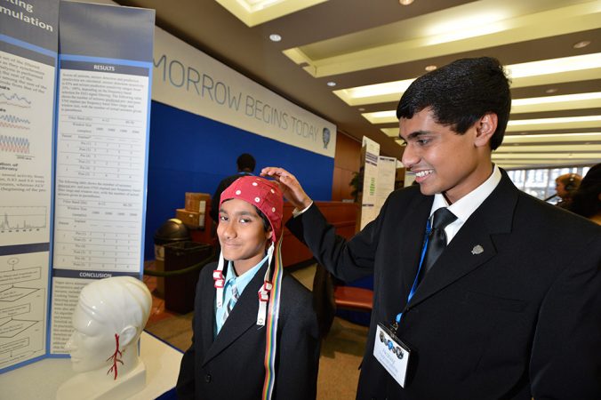 Akaash Padmanabha, 11, wears a cap that allows the electrical activity of his brain to be recorded. His older brother, Akshay, 17, made an important discovery about electrical activity in the brains of some people. Credit: Chris Ayers Photography/SSP