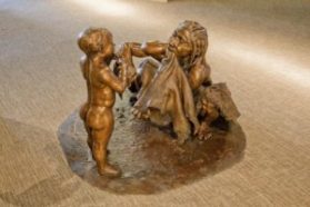 This sculpture by John Gurche shows a female Neandertal teaching her child how to poke holes in animal hide. Sculpture: credit: 2010, John Gurche; Photo: Chip Clark, Smithsonian Institution