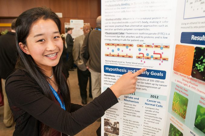 Kelly Zhang, 17, discovered a way to help surgeons visualize cancer cells, which can resemble normal cells. She dyed microscopic particles, then added them to cells. Cancer cells took up more of the dye. This made them glow brightly. Credit: Chris Ayers Photography/SSP