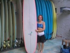Emily picks a surfboard.