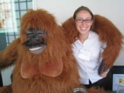 Emily with a large stuffed animal, orangutan-style.