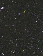 The most distant galaxy (bottom arrow) identified so far, imaged as a faint splotch.
