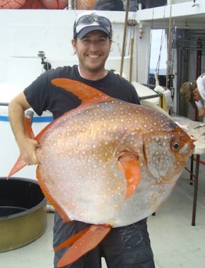 biologist holding opah fish