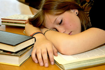 girl sleeping on books