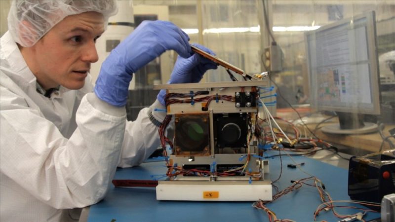 Cordell Grant, an aerospace engineer at the University of Toronto in Canada, assembles one of his team’s nanosatellites. These are the smallest space telescopes ever sent into Earth orbit. Credit: Johannes Hirn (Dunlap Institute for Astronomy & Astrophysics, University of Toronto)