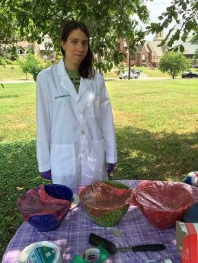 The author standing in front of a table of cookie at the park.