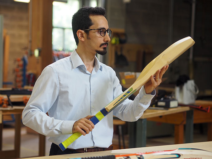 a man holding a cricket bat