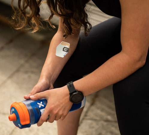 a photo showing the sweat sensor patch on a woman's arm