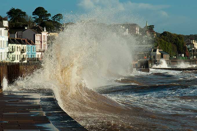 a wave breaking on a seawall