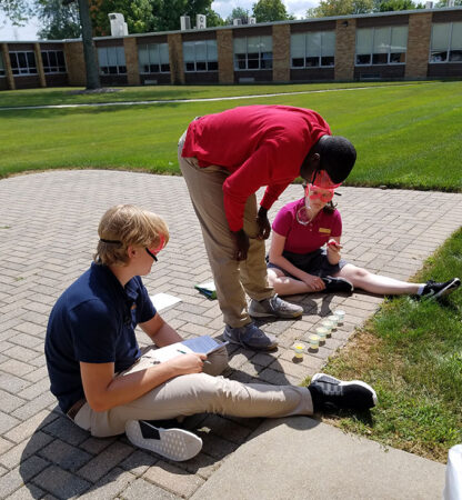 students outside doing a bubble lab experiment