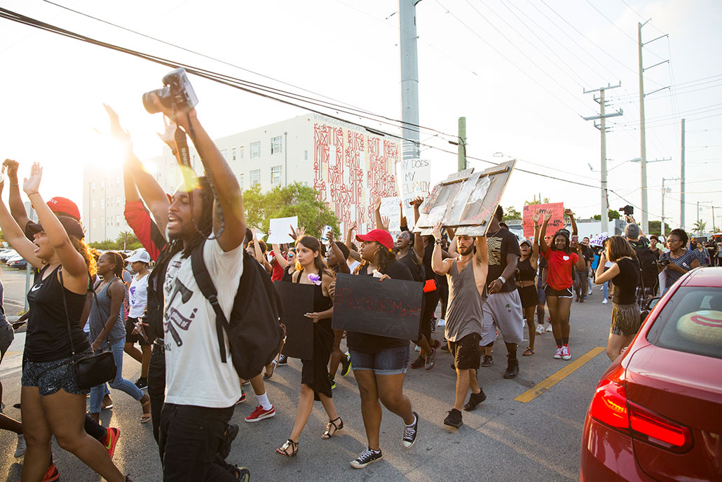a photo of protesters marching in a Black Lives Matter march