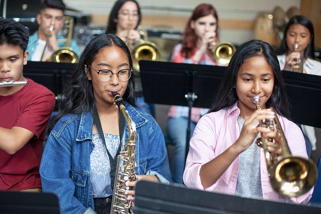 a group of teenagers at band practice