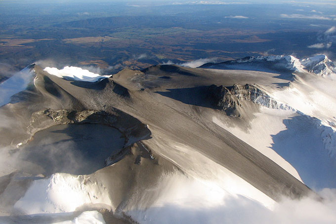 volcanic ash on snow covered mountaintop