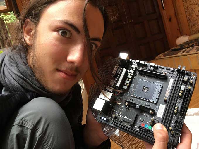 Nathaniel Mills holding part of the computer he built