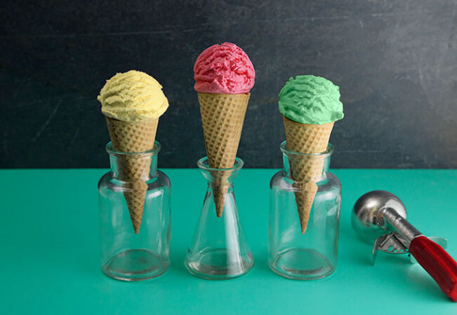a photo of three ice cream cones with different flavors of ice cream in each