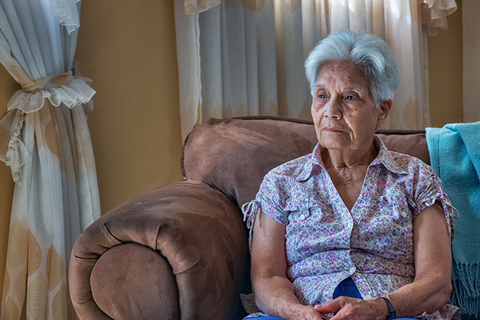 an senior Venezualan woman sitting on a sofa