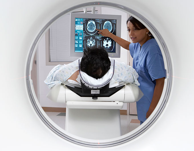 a photo of a person's head in an MRI machine and a nurse explaining a brain scan