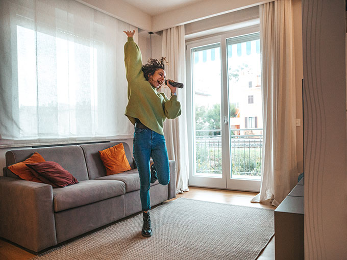 a girl dancing and singing into a microphone