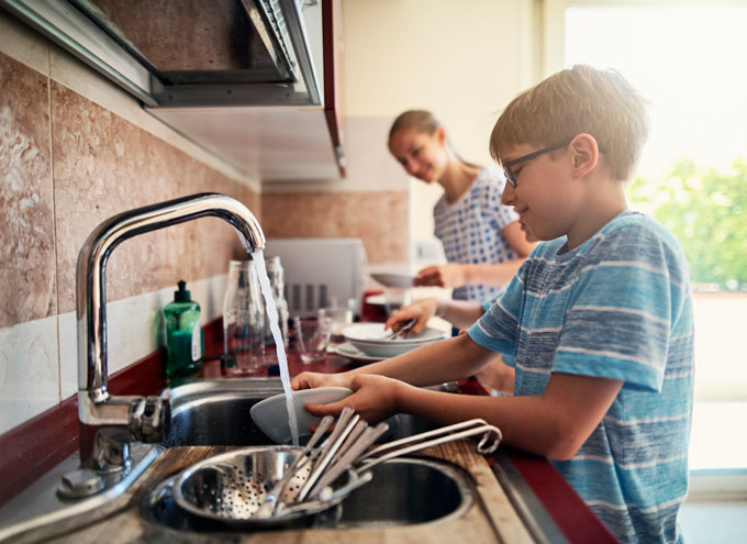 a boy and a girl doing dishes