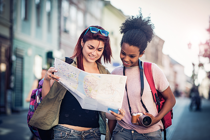 two girls looking at a map