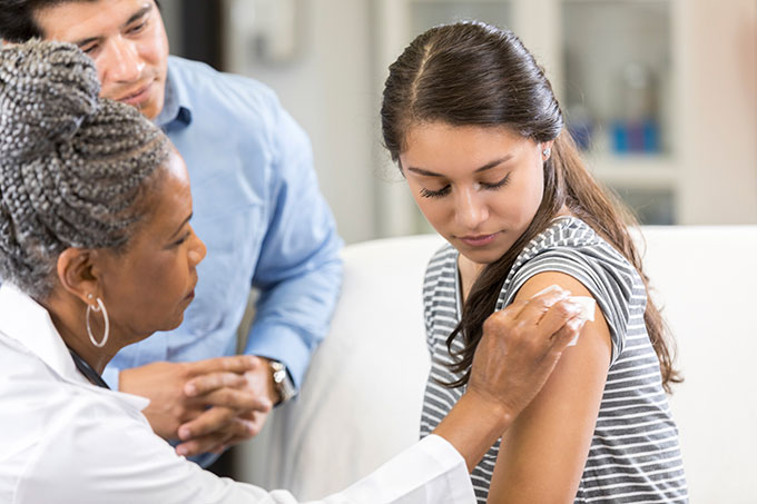 a girl getting vaccinated