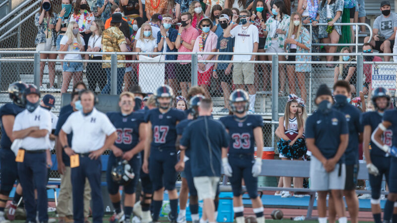 Football players, coaches and fans at a game in Utah