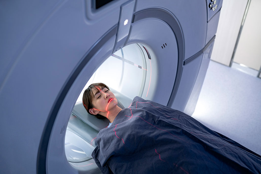 a woman enters an MRI scanner