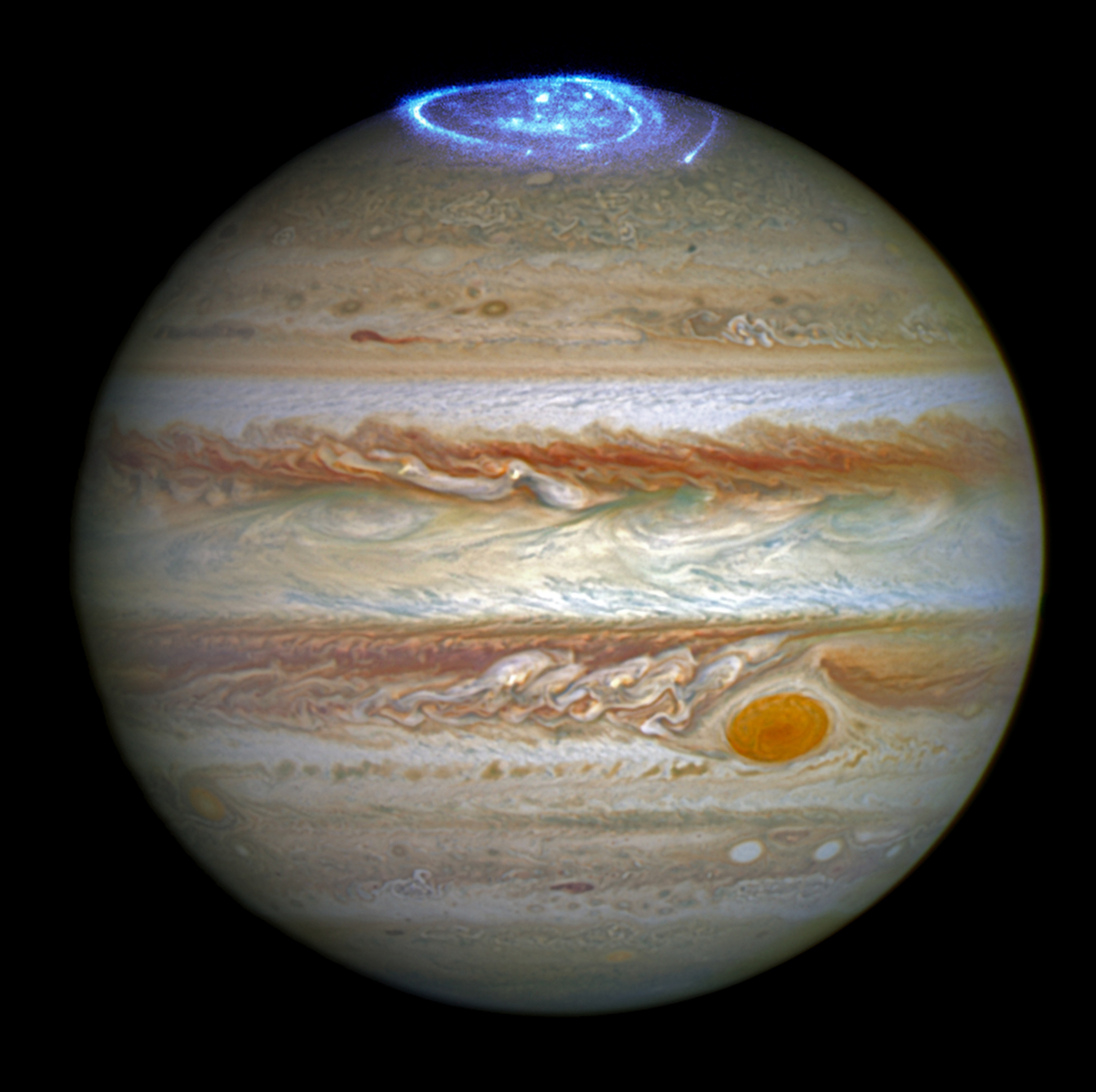 telescope images of Jupiter show ultraviolet auroras in blue over the planet's north pole