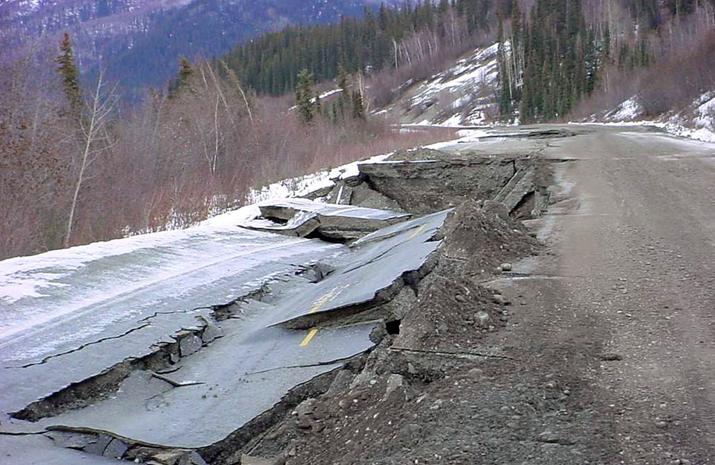 a photo of an asphalt road destroyed after an earthquake