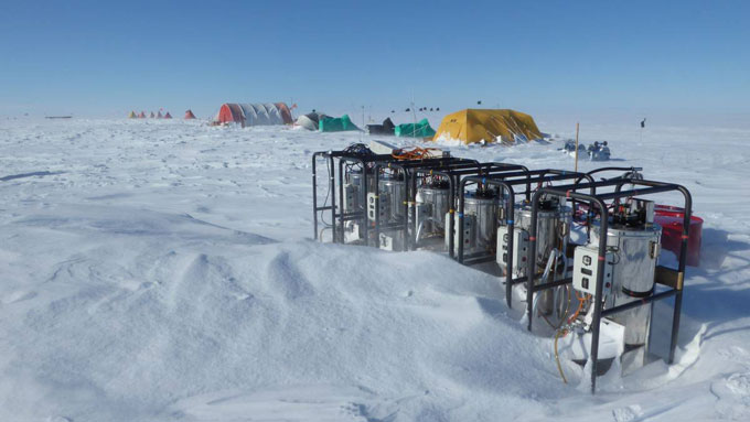 image of water heaters sounded by snow and ice with tents in the background