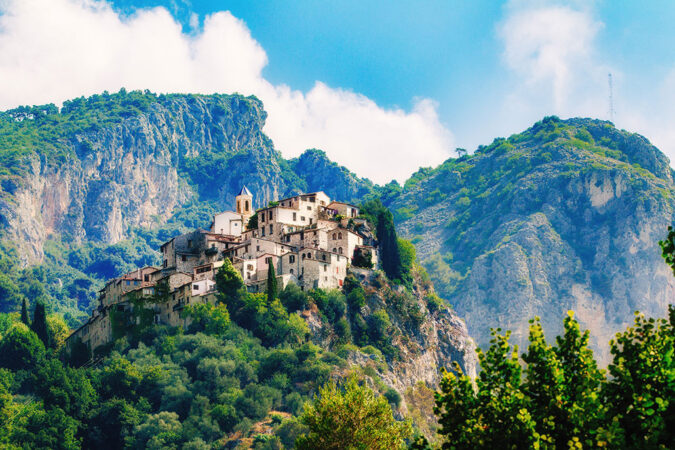 a photo of a small hilltop village in the mountains