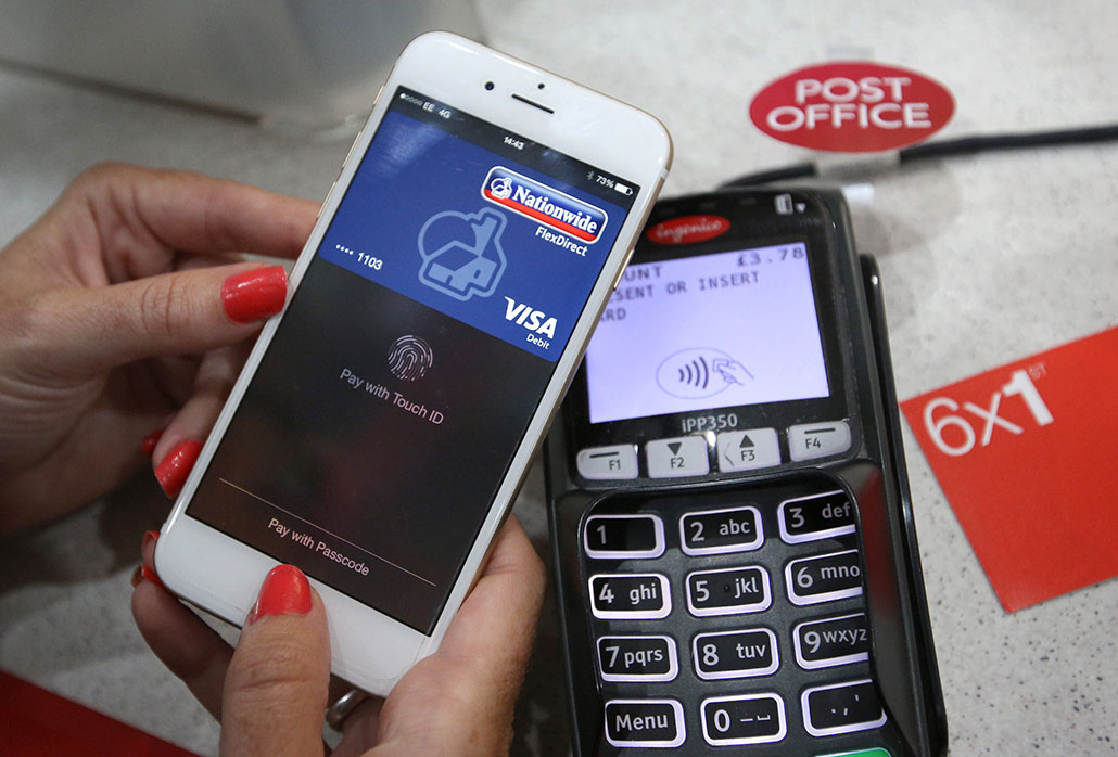 a photo of a person using a mock-up of a digital credit card to make a payment