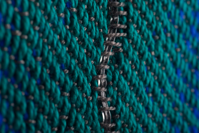an image of a special fiber woven into blue and green fabric