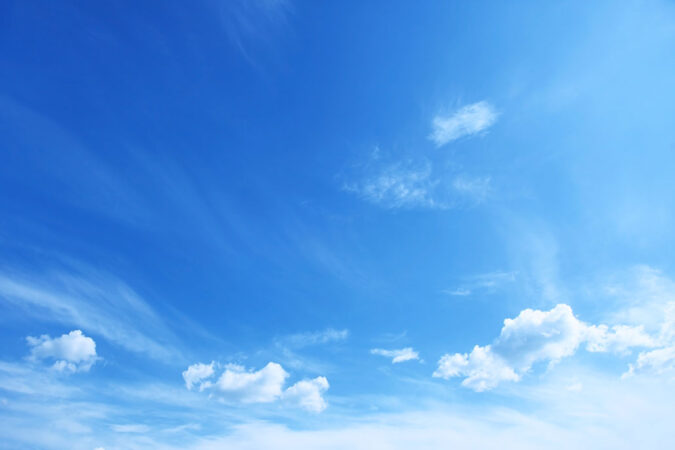a picture of a very blue sky with wispy white clouds