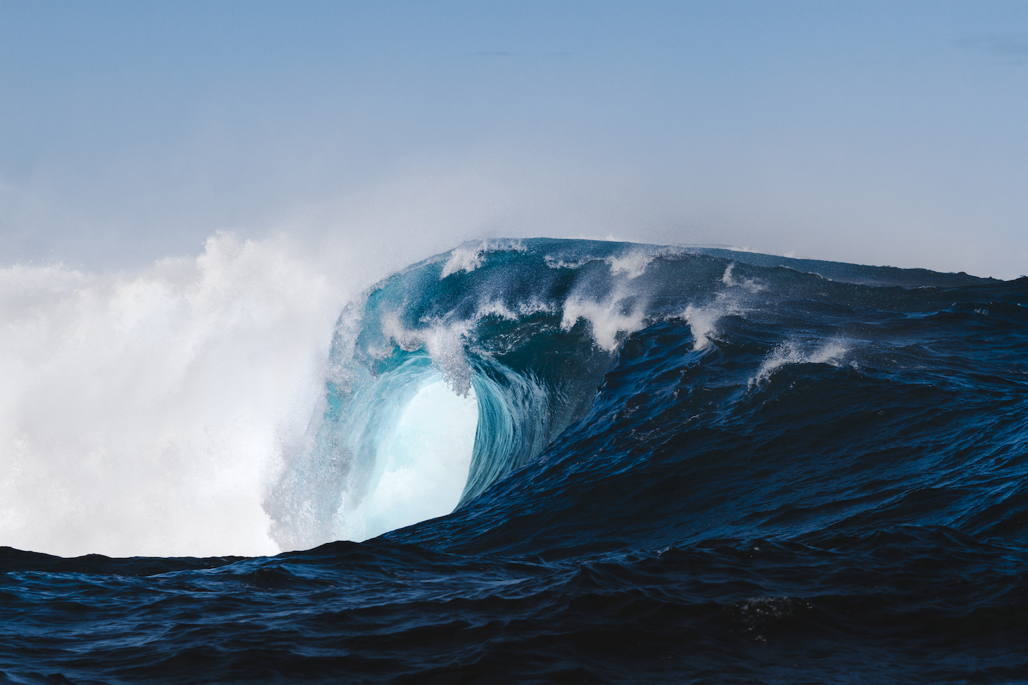 a photo of an ocean wave starting to curl under