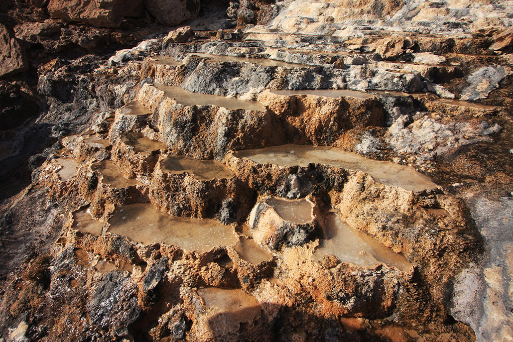 a natural spring showing stairstep terrace pools