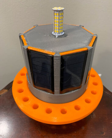 a photo of an octagonal black and orange buoy